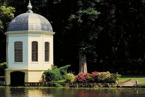 a small house surrounded by water